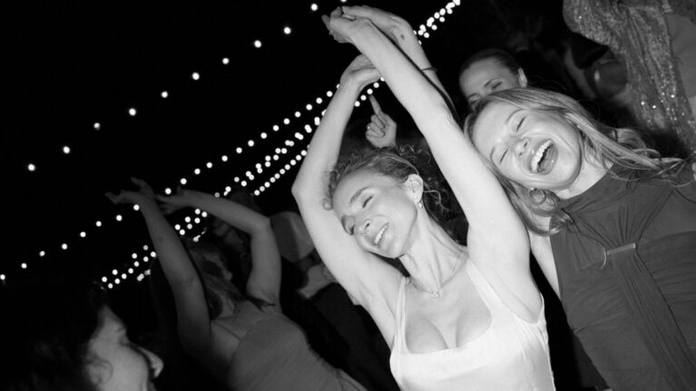 Hannah + Gary Guests joyfully dancing under string lights at a wedding reception, celebrating with laughter and drinks. This vibrant atmosphere highlights the energy brought by live wedding bands, showcasing Napa Valley Live Wedding Bands Music Entertainment as a perfect choice for unforgettable celebrations. Ben Mallare Events & Entertainment specializes in creating memorable experiences that keep guests on the dance floor all night long.